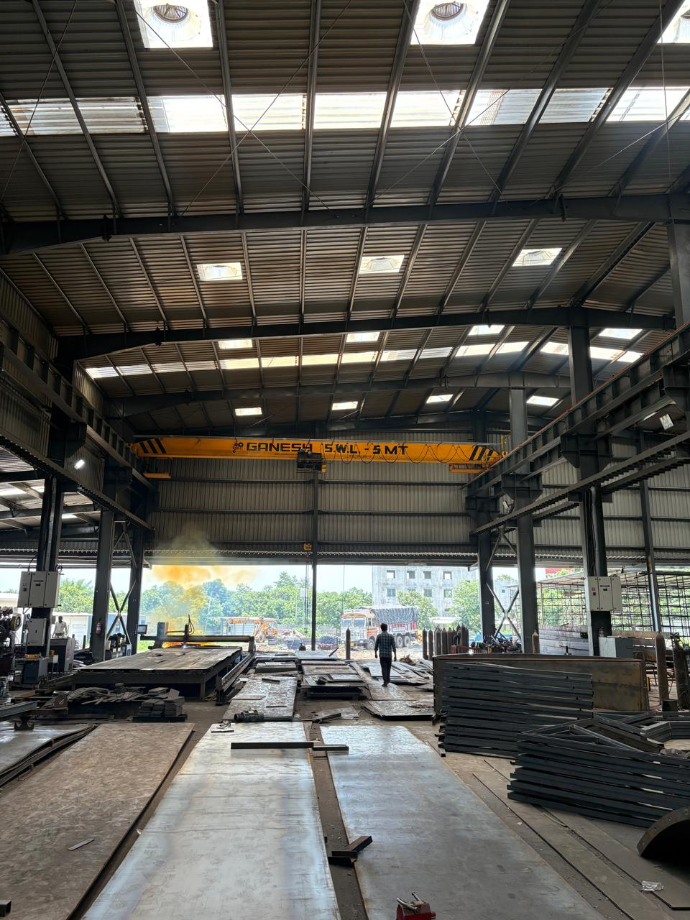 Operational high-tonnage EOT crane supported by a precision PEB steel structure, demonstrating the dependability of our detailed structural drawings - detailed peb design - shreeses